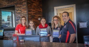 A selection of Ralph's technicians holding up various awards.