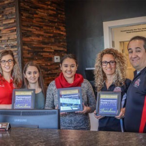 A selection of Ralph's technicians holding up various awards.