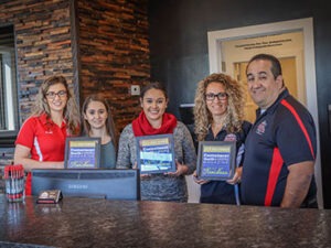 An image of the owners and employees in the Ralph's Transmission lobby.