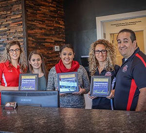 An image of the owners and employees in the Ralph's Transmission lobby.
