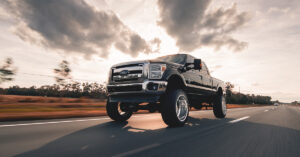 An image of a raised black, Ford truck.