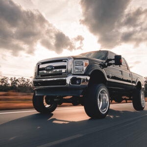 An image of a raised black, Ford truck.
