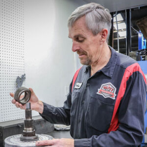 A Ralph's technician displays car maintenance on parts.