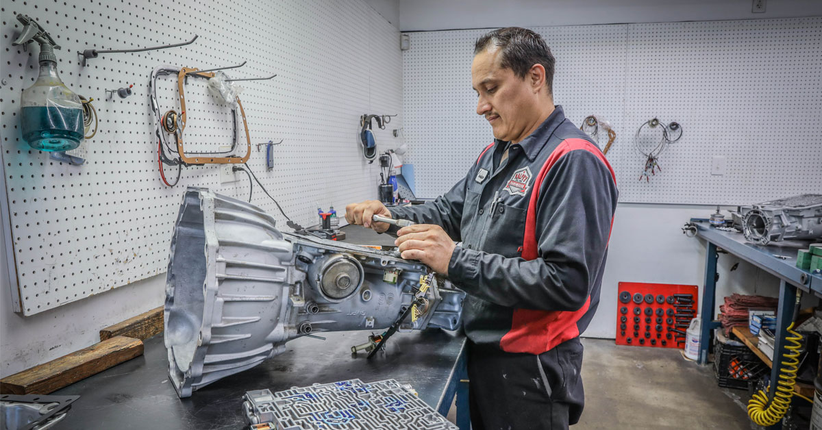 A Ralph's technician works on a part that is separated from the vehicle.