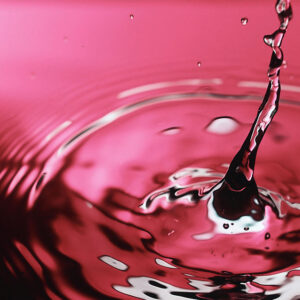 An image of a drop plopping into water.