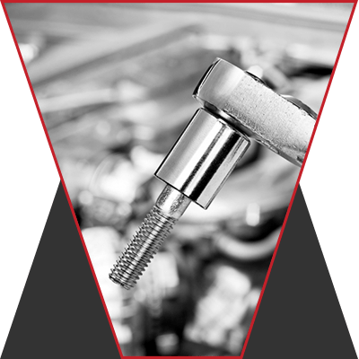 An image of a tool holding a silver screw part.