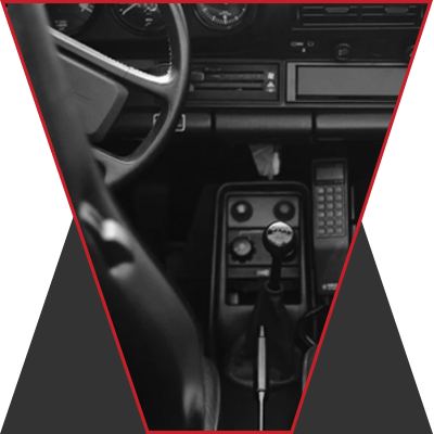 The image of a steering wheel and front console with the transmission stick.