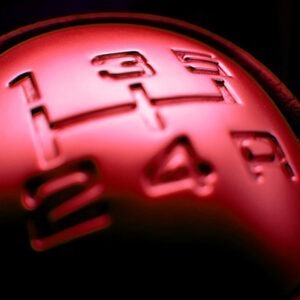 A close up of a shifter on a manual vehicle.