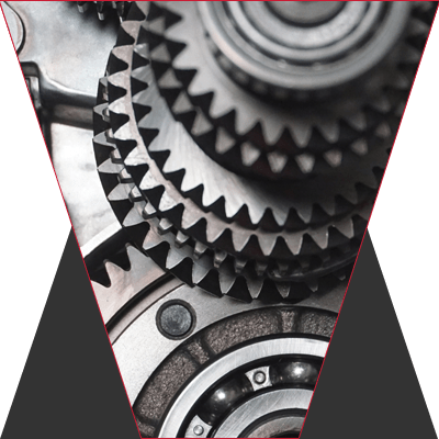 A black and white photo of several gears working together.