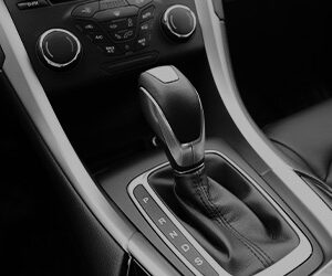 The image of an automatic shifter in a car.
