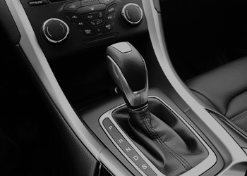 The image of an automatic shifter in a car.