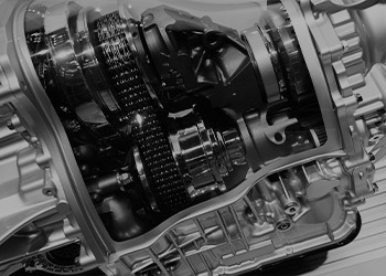 A black and white photo of a sleek transmission.