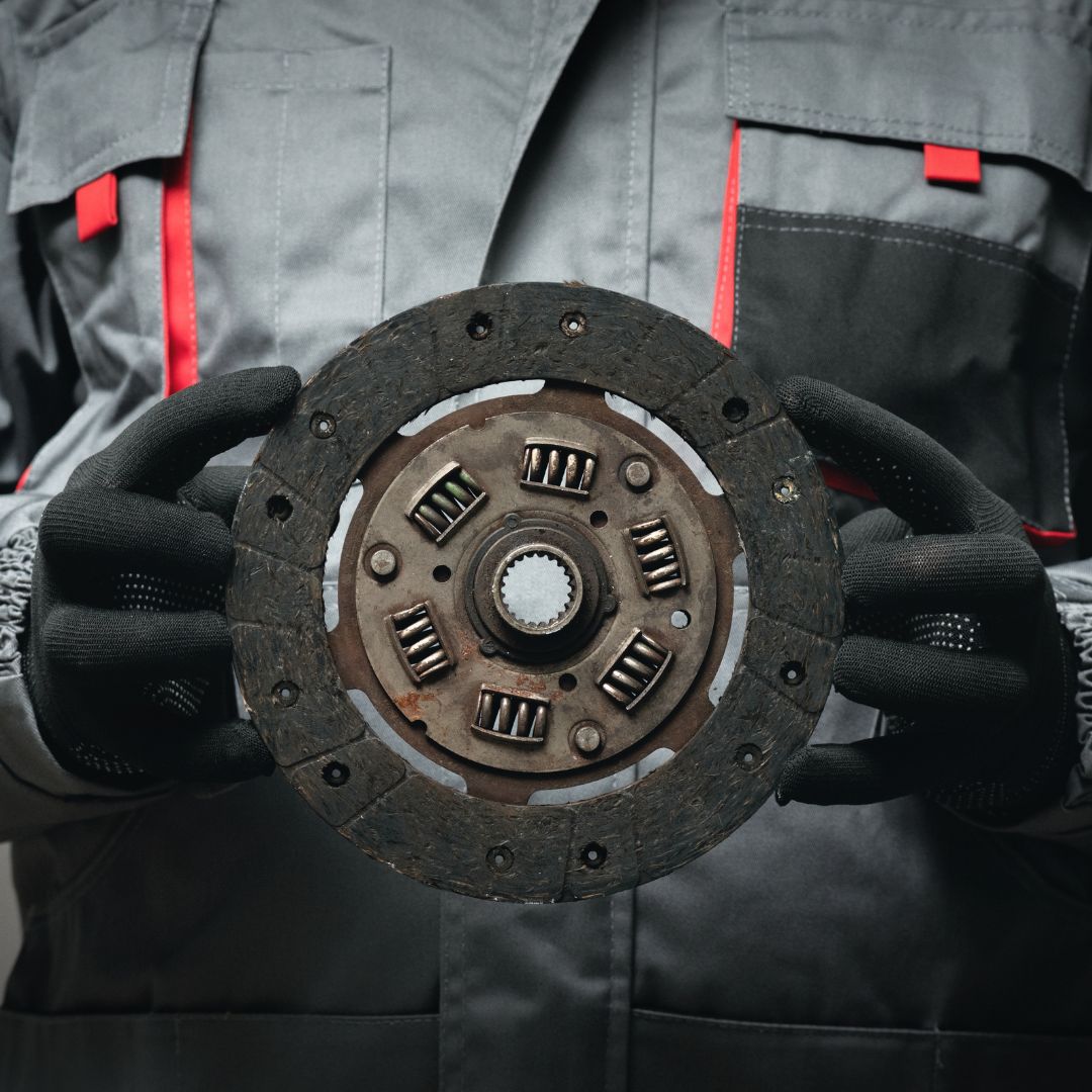 mechanic holding clutch
