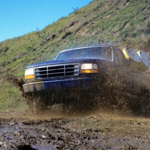 a truck driving through mud