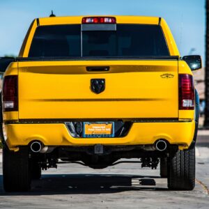 a yellow truck driving down a street