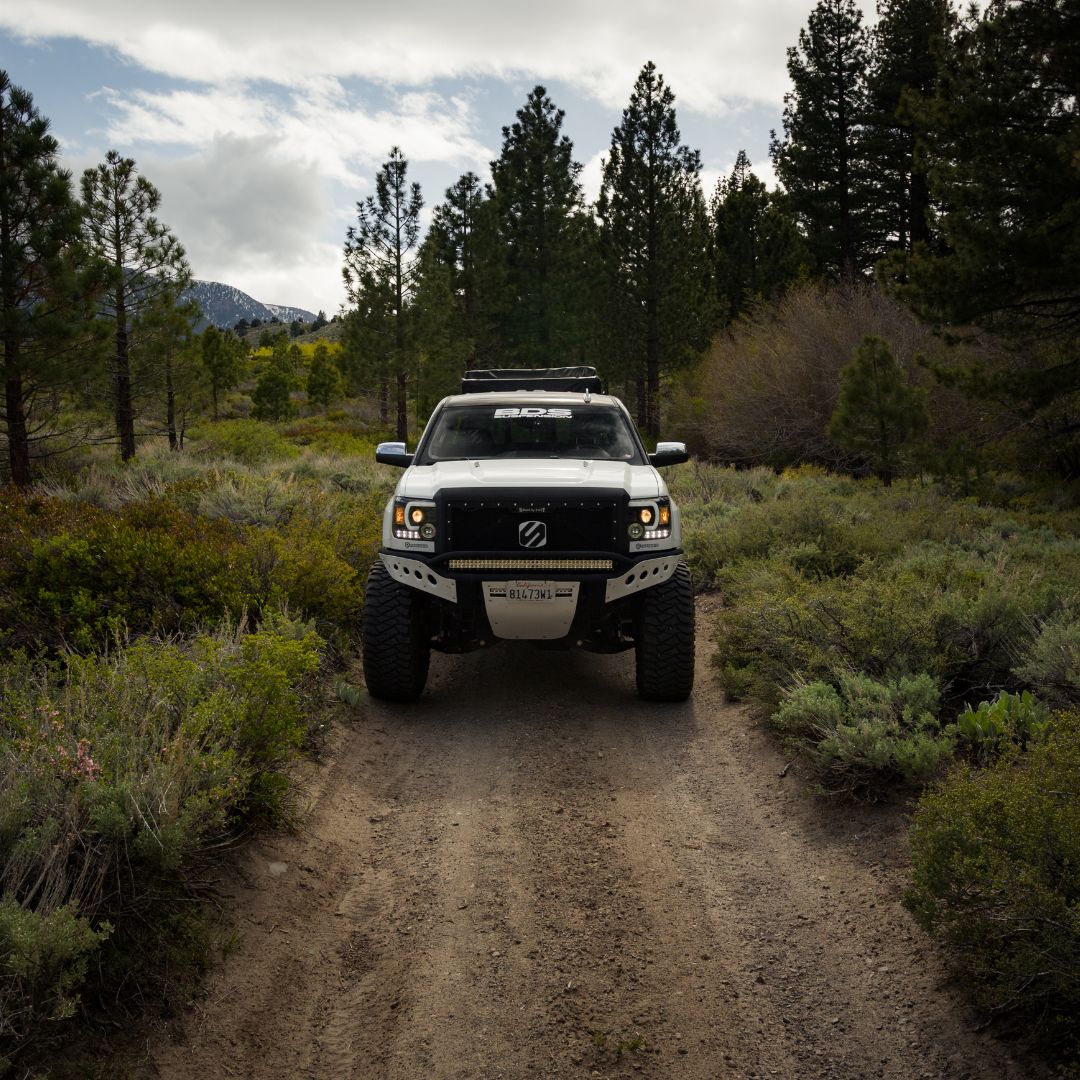 a truck driving down a dirt road
