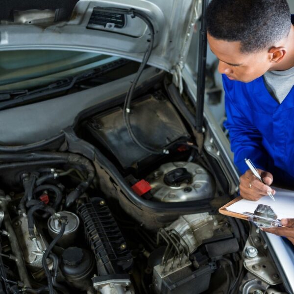 person looking at car engine